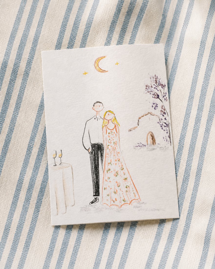 Pareja de invitados mostrando una ilustración DELUNA